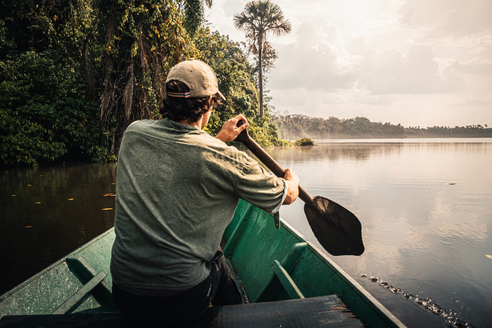 Guide paddling a canoe in the Amazon Rainforest