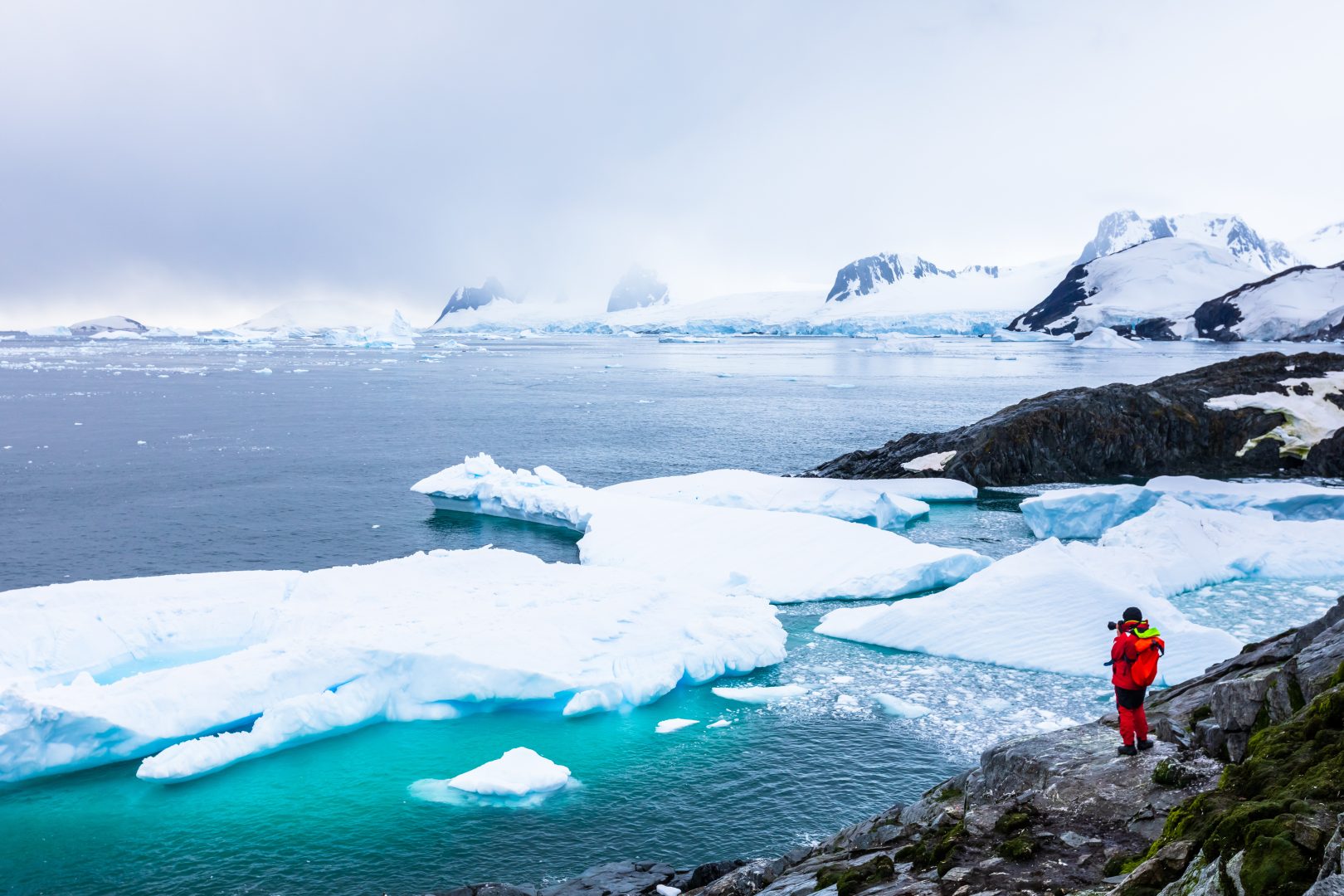 Tourist photographing glaciers in Antarctica