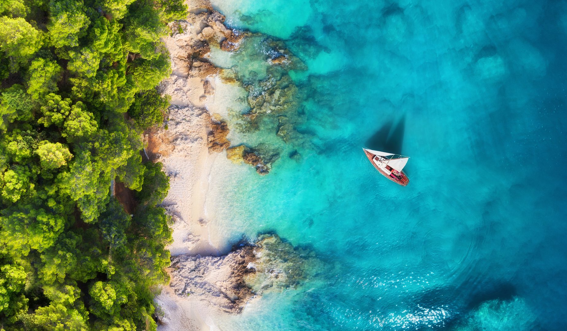 A secluded, private beach with a yacht in Croatia