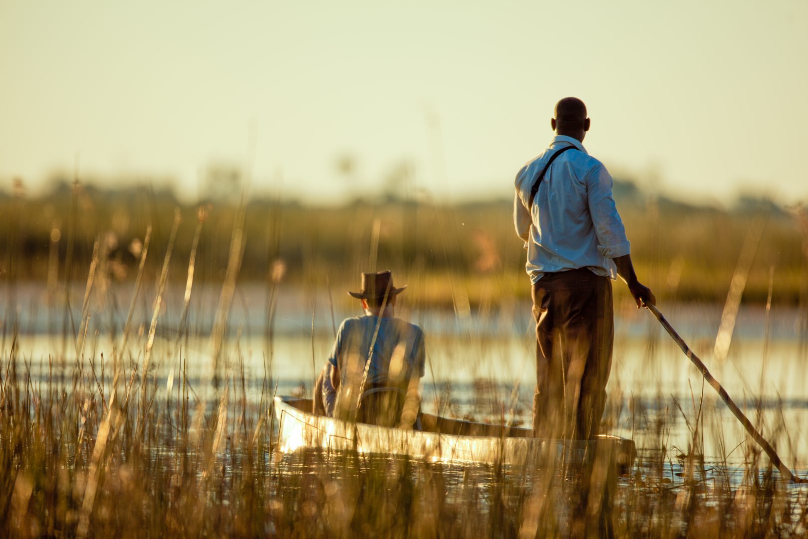 A guide pushing a mokoro in Botswana