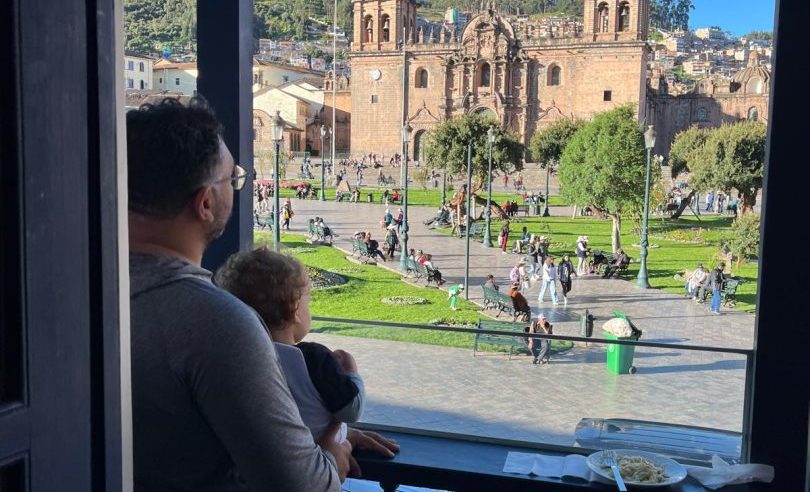 Rachel Harris's husband and toddler looking out over Cusco's Plaza de Armas