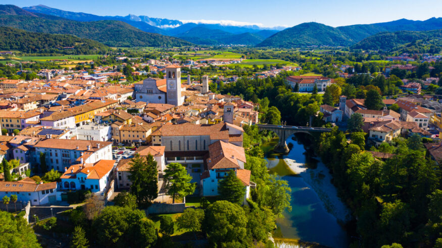 Scenic aerial view of historic centre of Cividale del Friuli on Natisone river with medieval stone Devil Bridge and Cathedral parish church, Italy