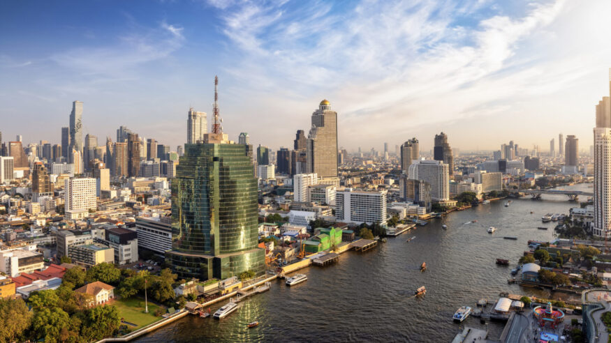 Beautiful panoramic sunset view of the skyline of Bangkok, Bang Rak and Sathon district, Thailand, along the Chao Phraya river