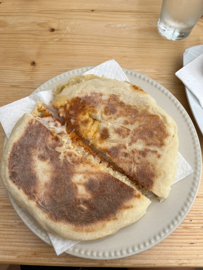 A delicious chorizo sandwich on a bolo levedo from the famous Gloria Moniz Cafe.