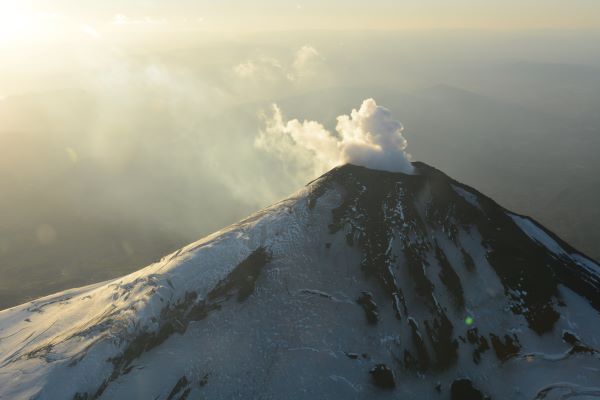 The steaming snow-capped top of Villarica Volcano in Chile.